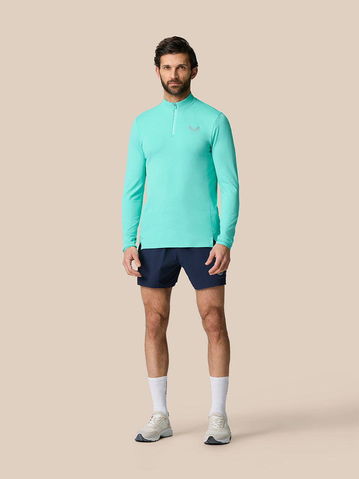 Model wearing Zone Training 1/4 Zip Top in light aqua with long sleeves and high neck for an athletic fit.