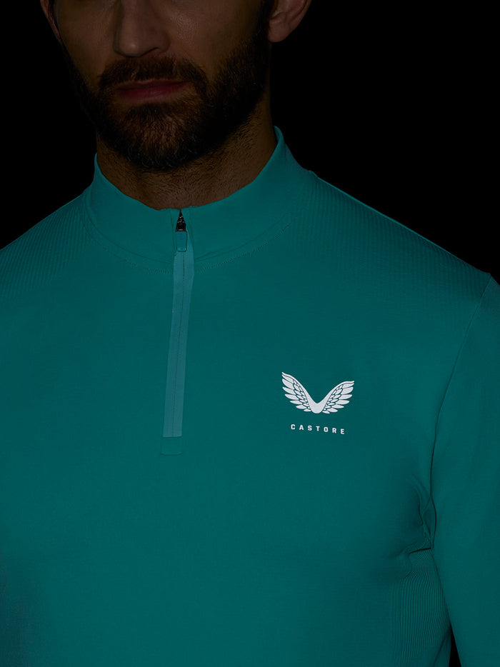 Front view of light aqua Zone Training top with center zip and left chest logo