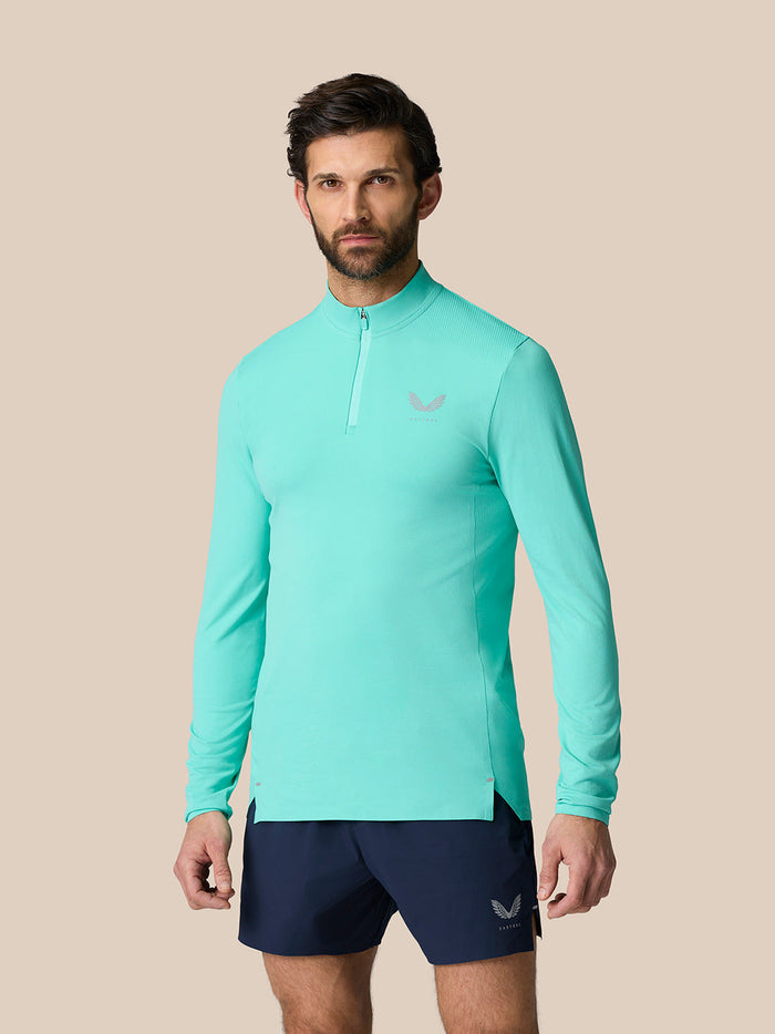 Light Aqua Zone Training 1/4 Zip Top with high neck and long sleeves and chest logo