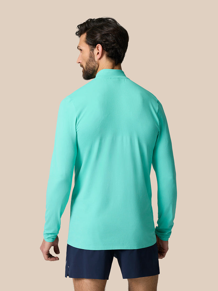 Back view of Light Aqua Zone Training 1/4 Zip Top showing ribbed back panel and extended hem