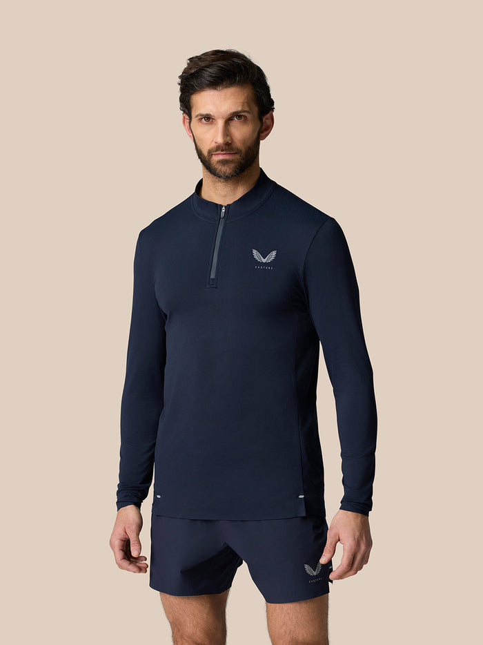Front view of a male model in midnight navy Zone Training 1/4 Zip Top with long sleeves and a zip at the neck.