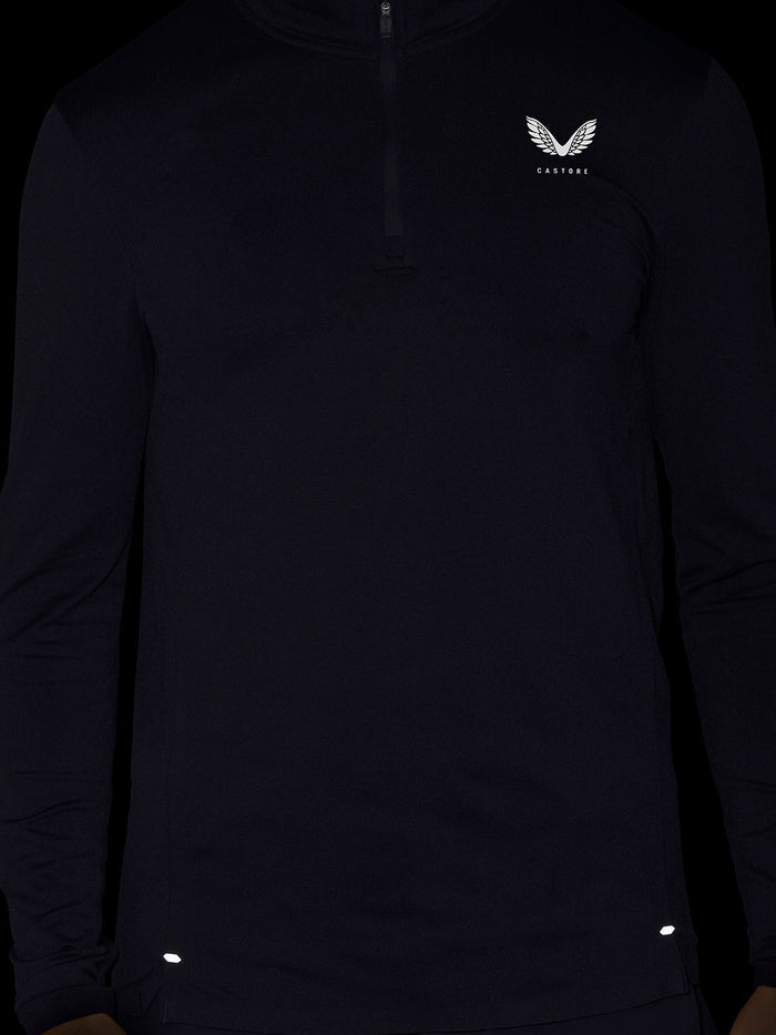 Close up of a black Zone Training 1/4 Zip Top with a small white logo on the left chest.