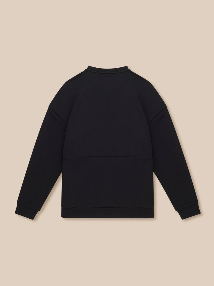 Back view of black Travel Lifestyle Sweatshirt against a beige background.