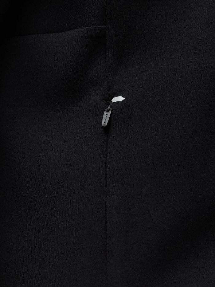Macro shot of the zipper area on the black Travel Zip Hoodie with Castore branding.