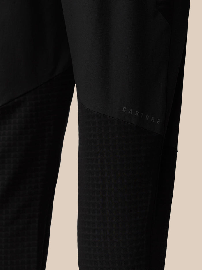 Close-up of black Flex Winterised Joggers leg showing Castore branding and textured panel