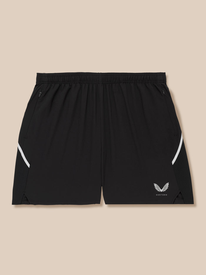 Back view of black Apex shorts with elastic waistband zip pockets and white side stripe plus Castore logo at the hem