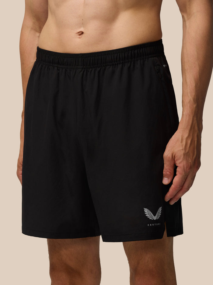Black Apex 6 inch shorts shown from the back with elastic waistband and Castore logo at the leg