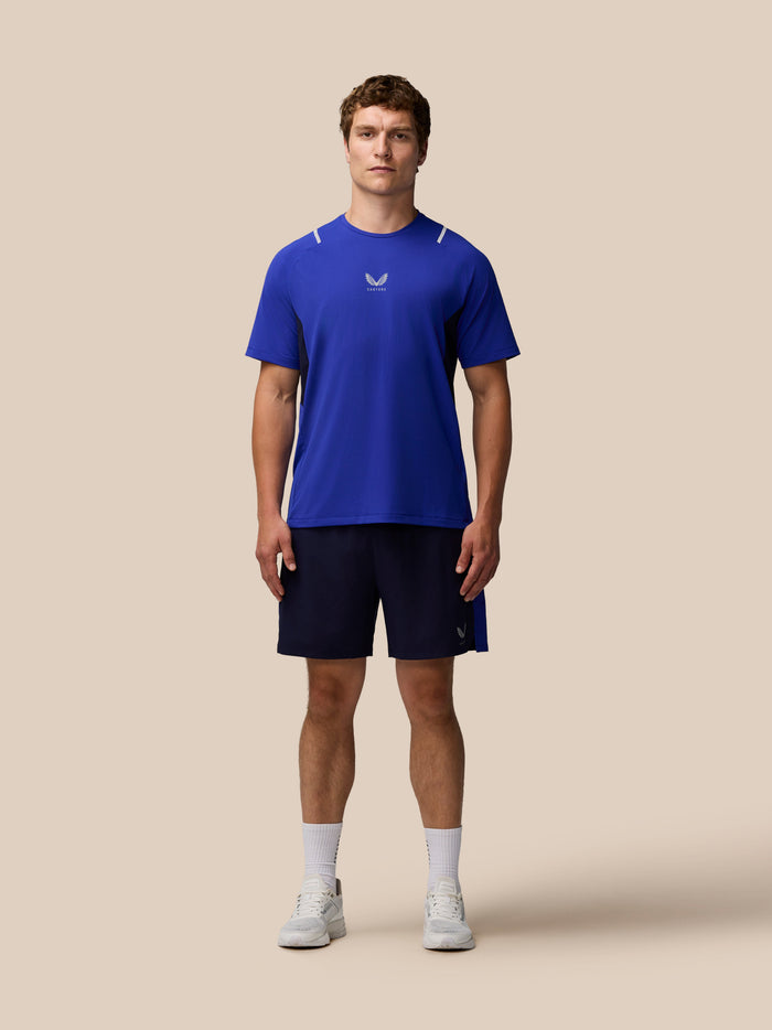 Male model in navy Apex Training 6 inch shorts with ProTek water resistance and Castore logo on the left leg