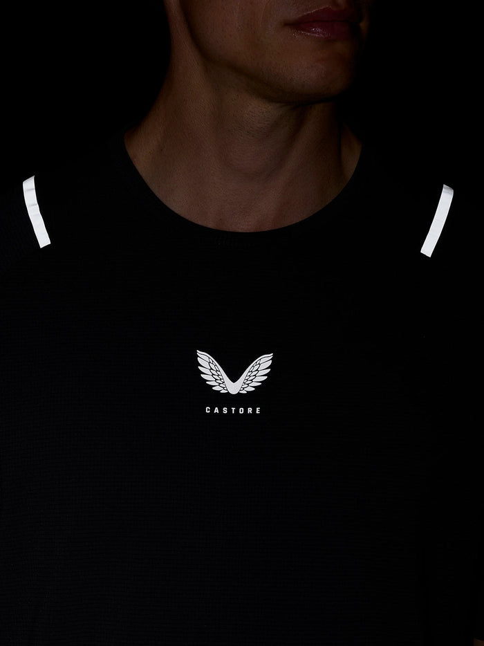 Close-up of chest area on black Apex Training T Shirt showing the Castore logo and reflective shoulder accents