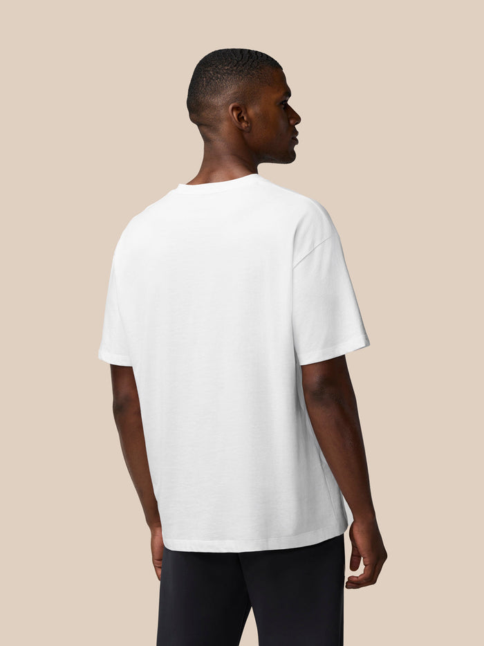 Back view of white Flex Cotton T Shirt on male model with relaxed fit