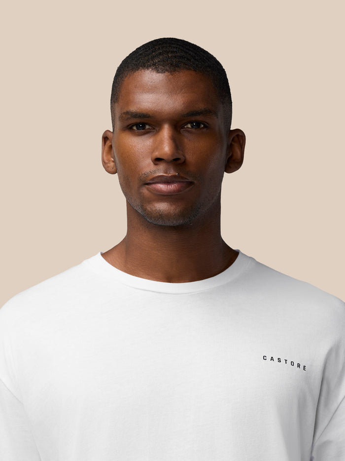 Male model wearing white cotton crew neck T shirt with CASTORE logo on the chest.
