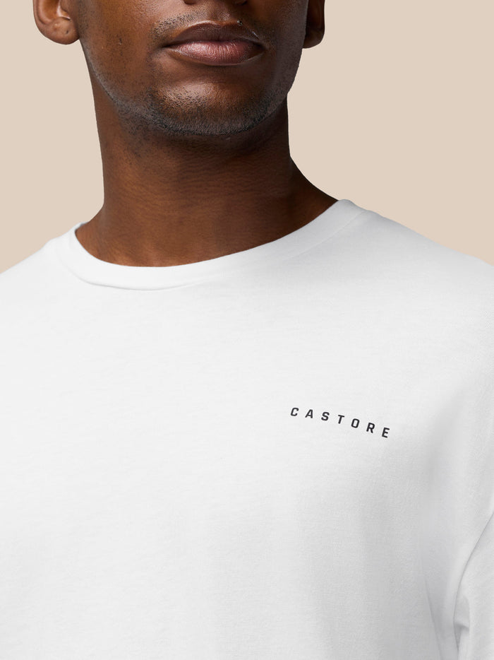 Close-up of white cotton T shirt chest showing CASTORE branding.