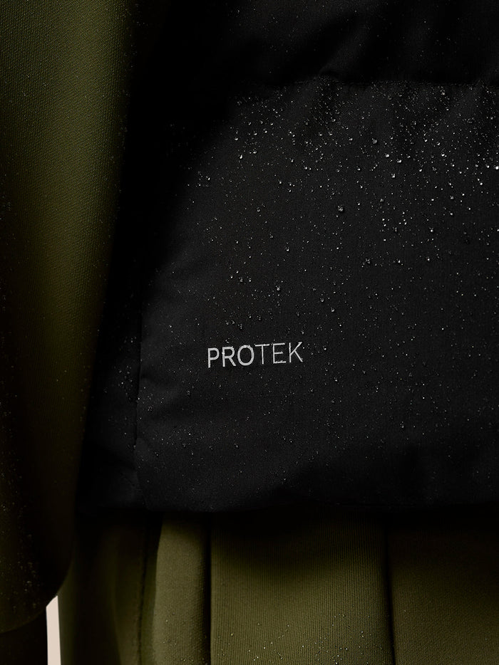 Close up of black ProTek water resistant fabric with droplets on a puffer gilet