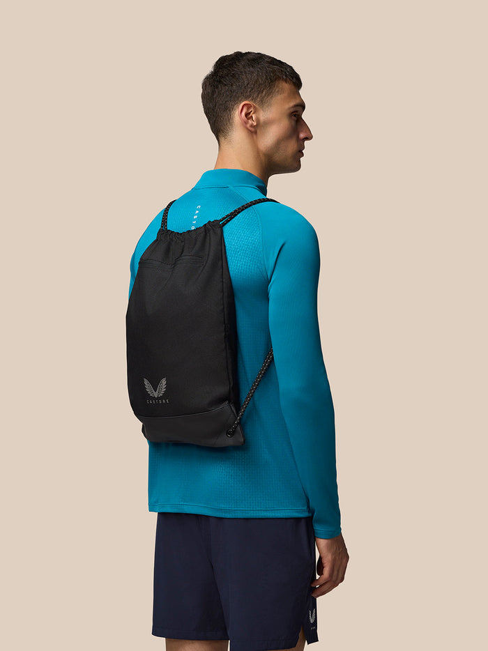 Unisex black Castore gym sack worn on a model with sack entry and two shoulder straps