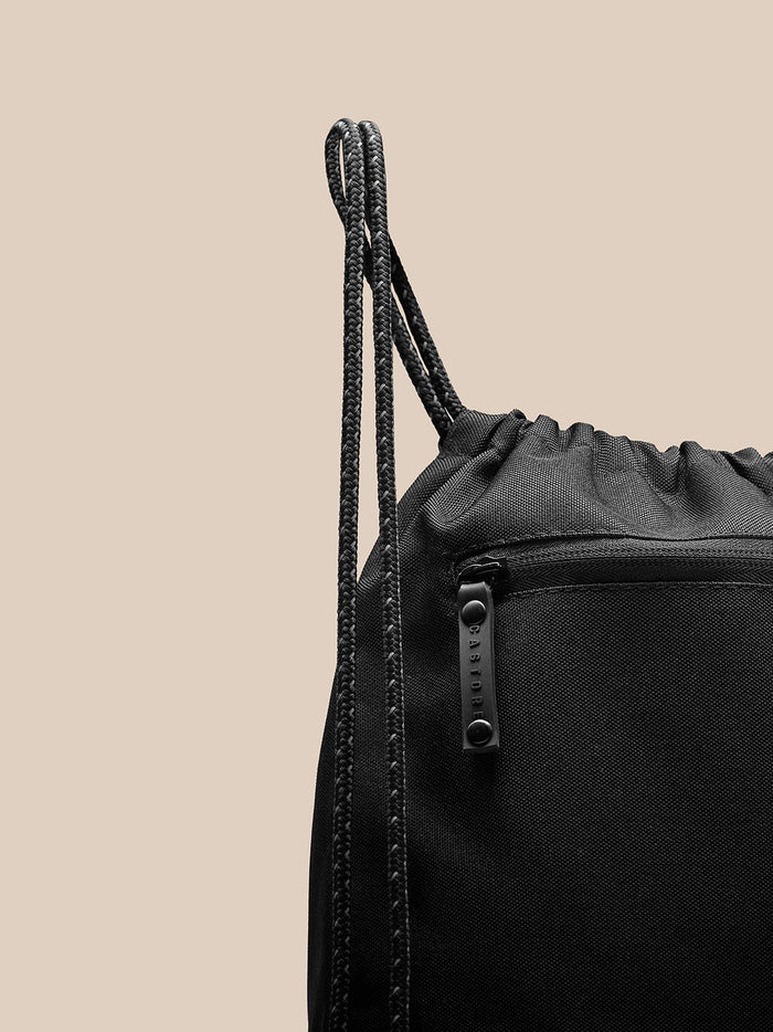 Close-up of braided drawstrings and top edge of the gym sack.