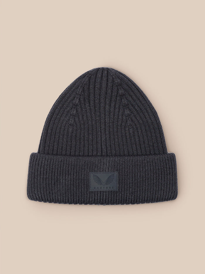 Dark grey ribbed knit beanie with folded cuff and Castore logo patch on the front.