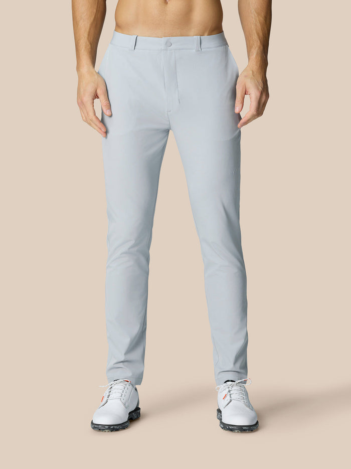 Back view of man in light grey Golf Club Trousers showing back pocket with Castore branding.