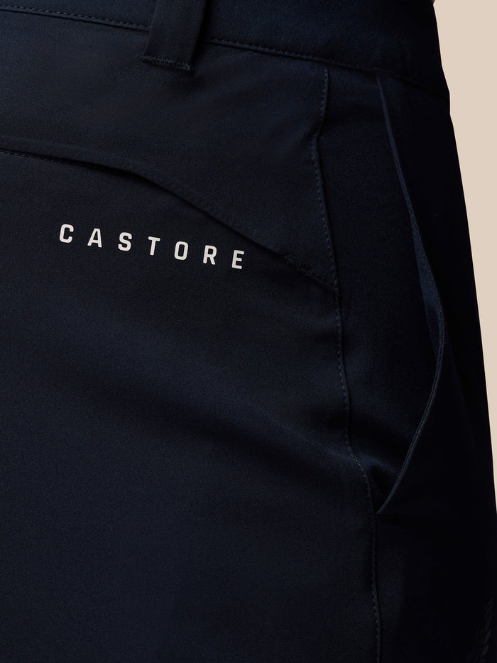 Close-up of the back of midnight navy golf trousers showing Castore branding on the pocket.
