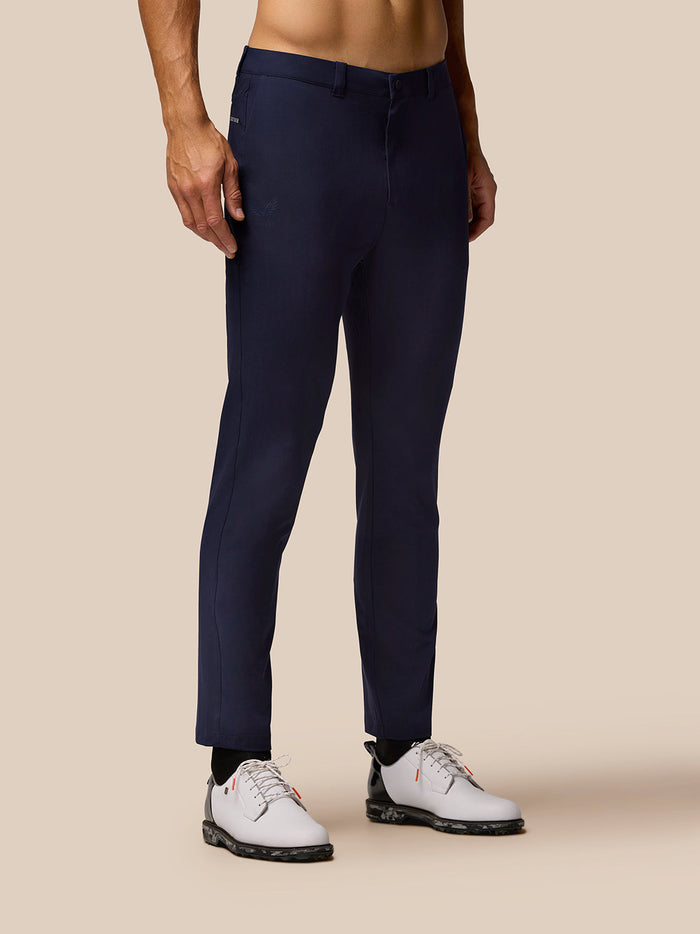 Male model wearing midnight navy Golf Lightweight Club Trousers back view showing belt loops and rear pocket.