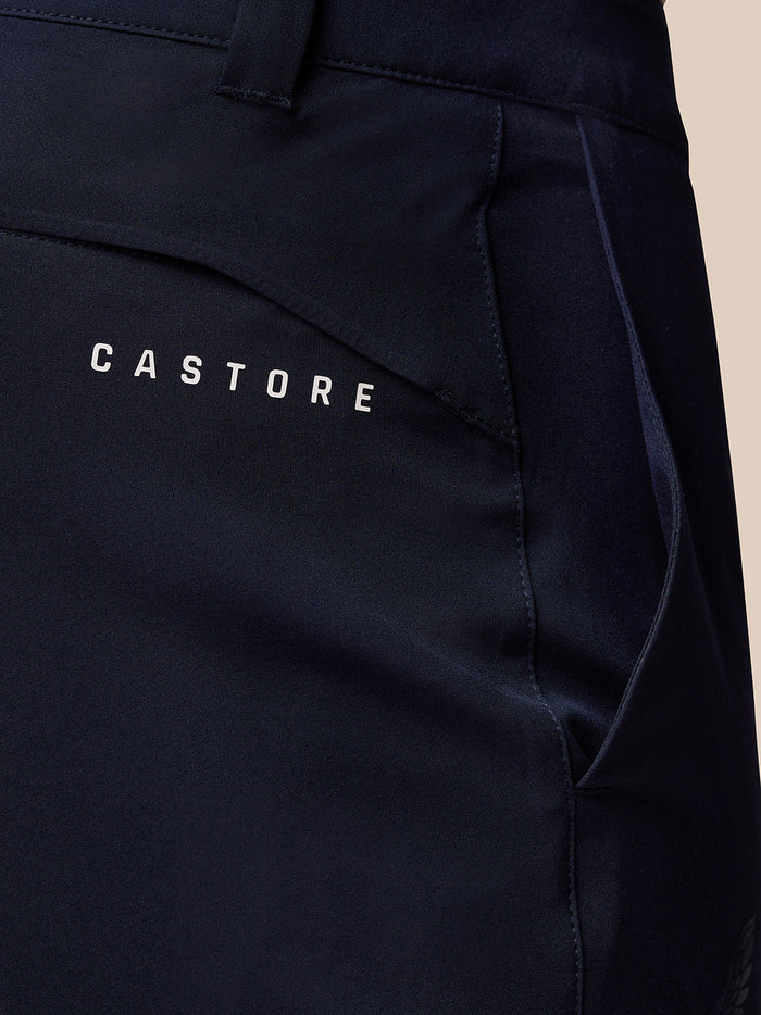 Close-up of midnight navy Golf Lightweight Club Trousers showing Castore logo on right thigh and ProTek branding at left rear waistband