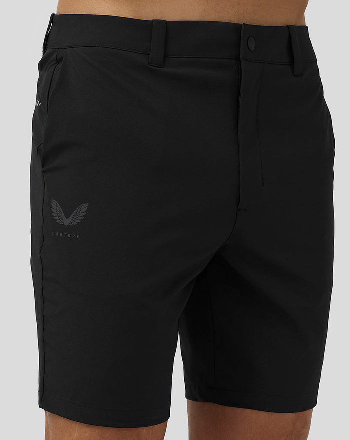 Back view of black men's golf shorts with Castore logo on back left hip and belt loops