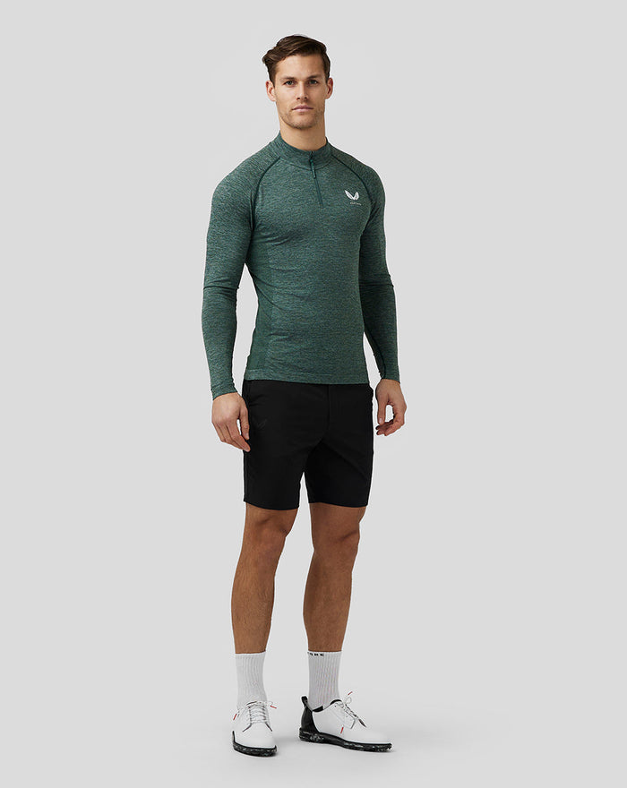 Male model wearing black water resistant golf shorts with open side pockets and a back welt pocket