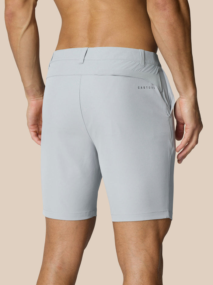 Back view of a man wearing light grey Castore Golf Club Shorts with a right rear pocket and branding on the thigh