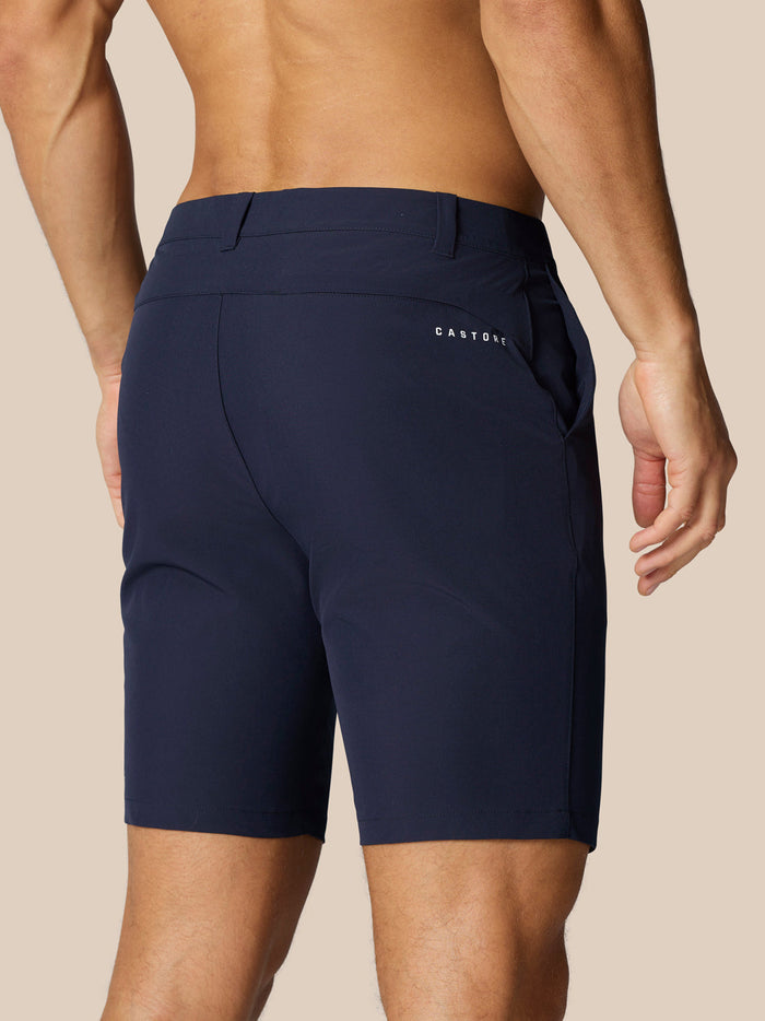 Rear view of navy golf shorts with Castore branding on the right rear and ProTek branding at the left rear waistband