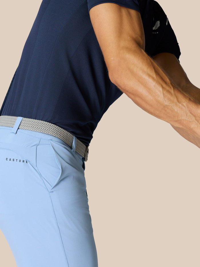 Side view of light blue golf shorts with braided belt, back pocket on right rear, and Castore branding on the right thigh
