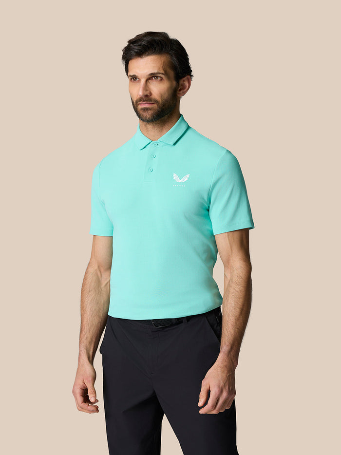 Male model in light aqua Club Essential Polo with button placket and logo on chest