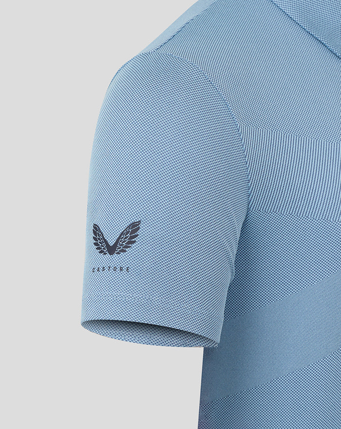 Castore logo on the sleeve of a sky blue engineered knit polo shirt