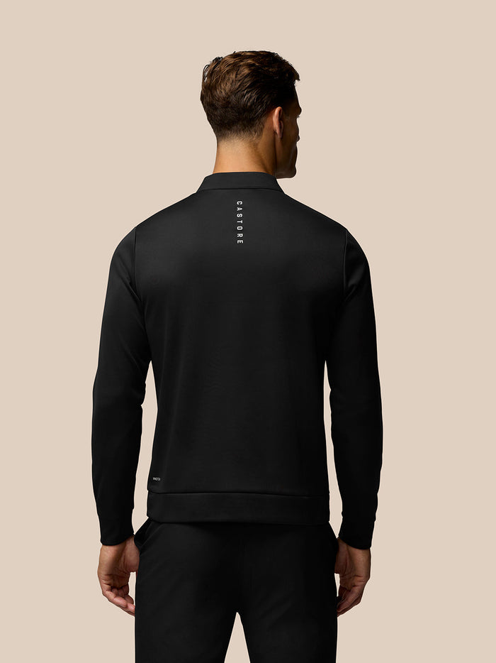 Back view of the black golf top showing vertical CASTORE branding down the center of the back.