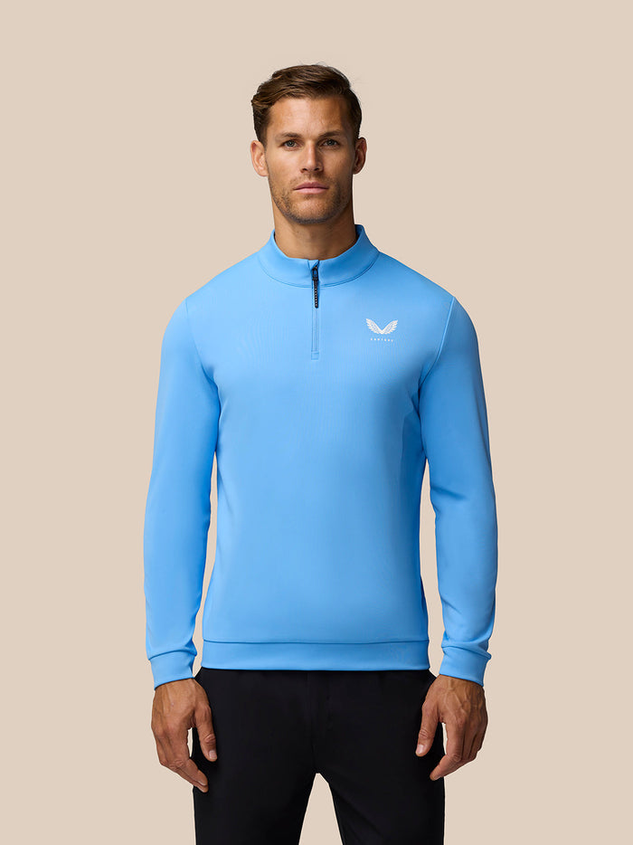 Male model wearing a cool blue Golf Club Classic quarter-zip top with chest logo