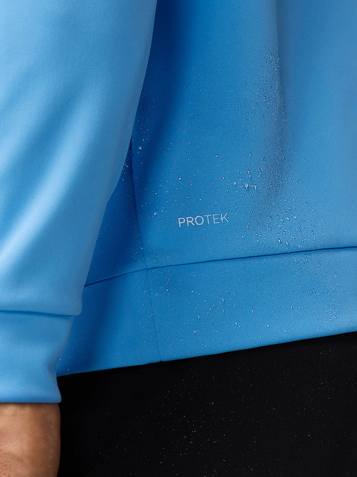 Close-up of blue ProTek fabric with droplets beading on the surface illustrating water resistance