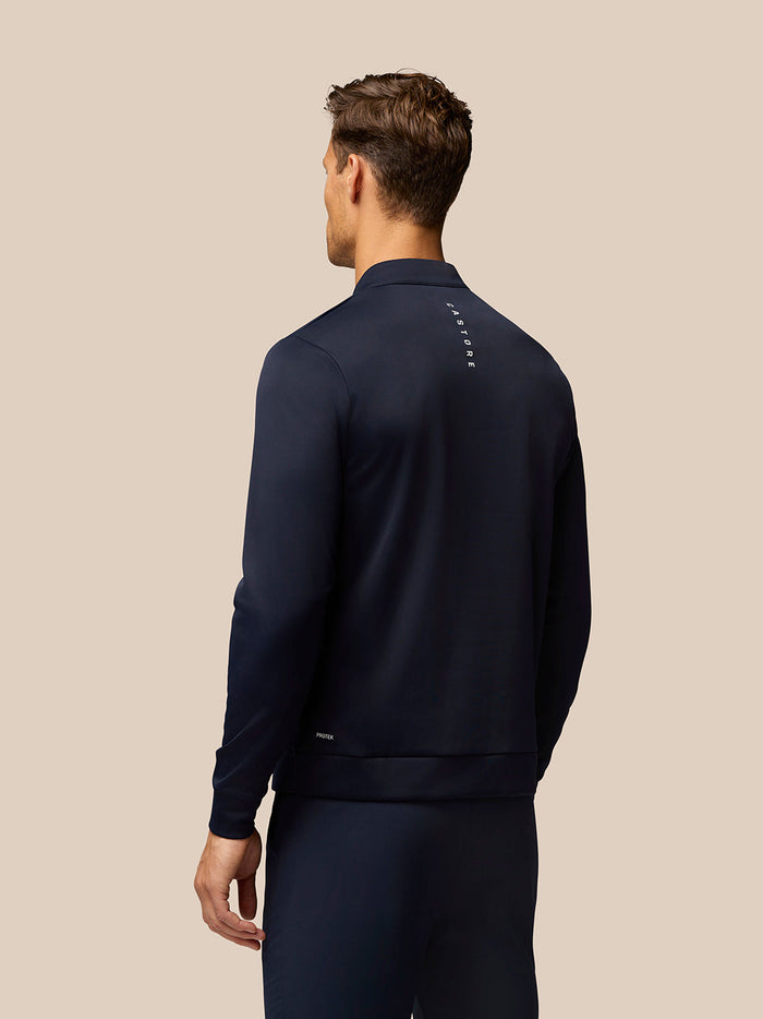 Back view of midnight navy Golf Club Classic quarter-zip top with vertical Castore branding along the upper back