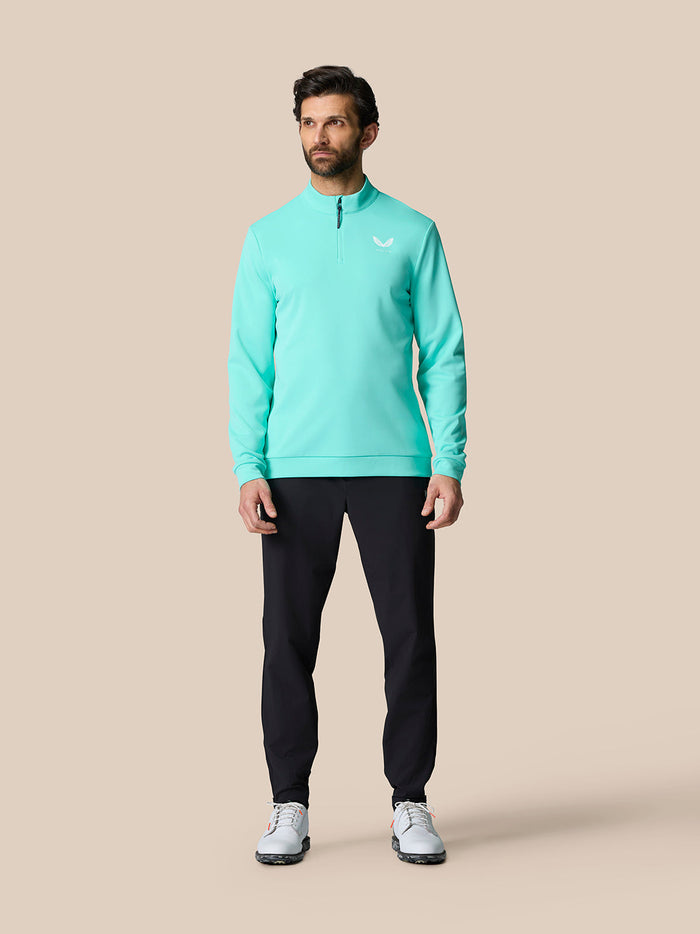 Model wearing a light aqua Golf Club Classic Quarter Zip Top with stand collar and ¼ zip