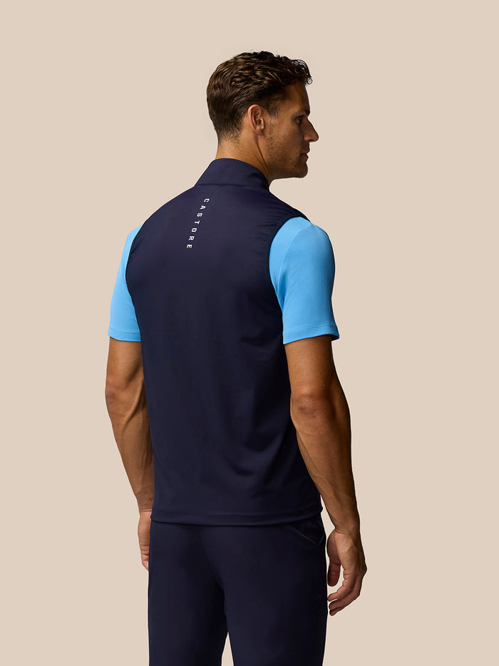 Back view of navy Pinnacle Gilet with Castore branding along the collar and upper back