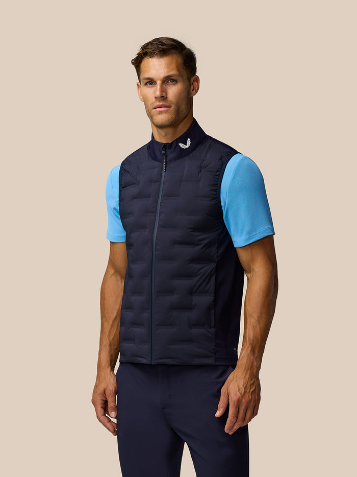 Front view of a male model in navy Pinnacle Gilet over a light blue tee.