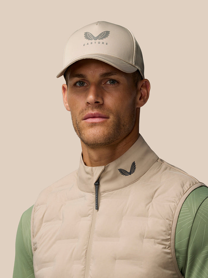 Male model wearing Mushroom Golf Pinnacle Gilet with front zip and quilted front panels