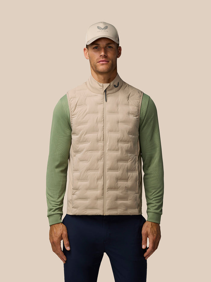 Male model wearing Mushroom Golf Pinnacle Gilet with front zip and quilted detail
