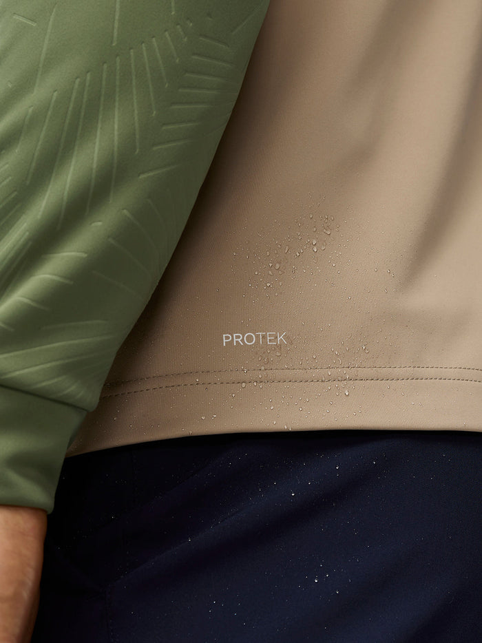 Close up of mushroom golf gilet fabric with ProTek water resistance and quilted detailing