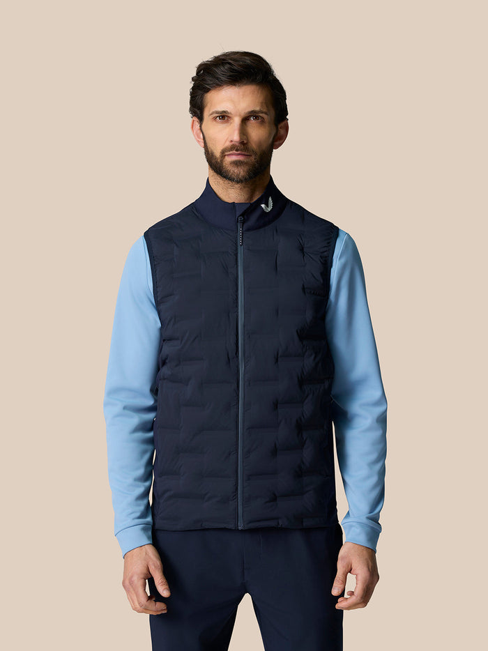 Male model wearing navy Pinnacle Gilet with light blue sleeves front view