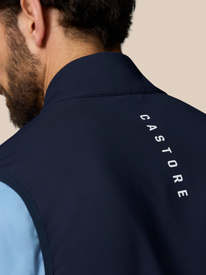 Back neck view of midnight navy Golf Pinnacle Gilet with Castore branding along the collar