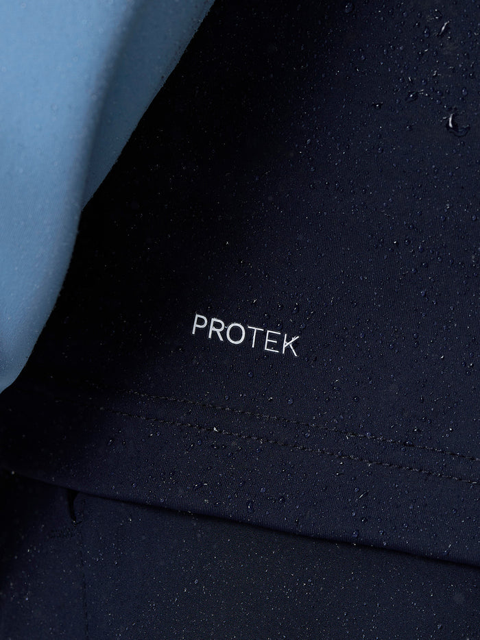 Close-up of navy Protek fabric with water droplets and PROTEK logo