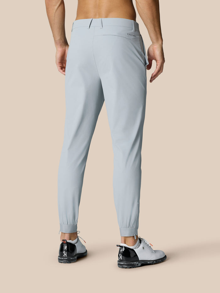 Back lower leg view of light grey Golf Pinnacle trousers showing zip cuffs at the ankles