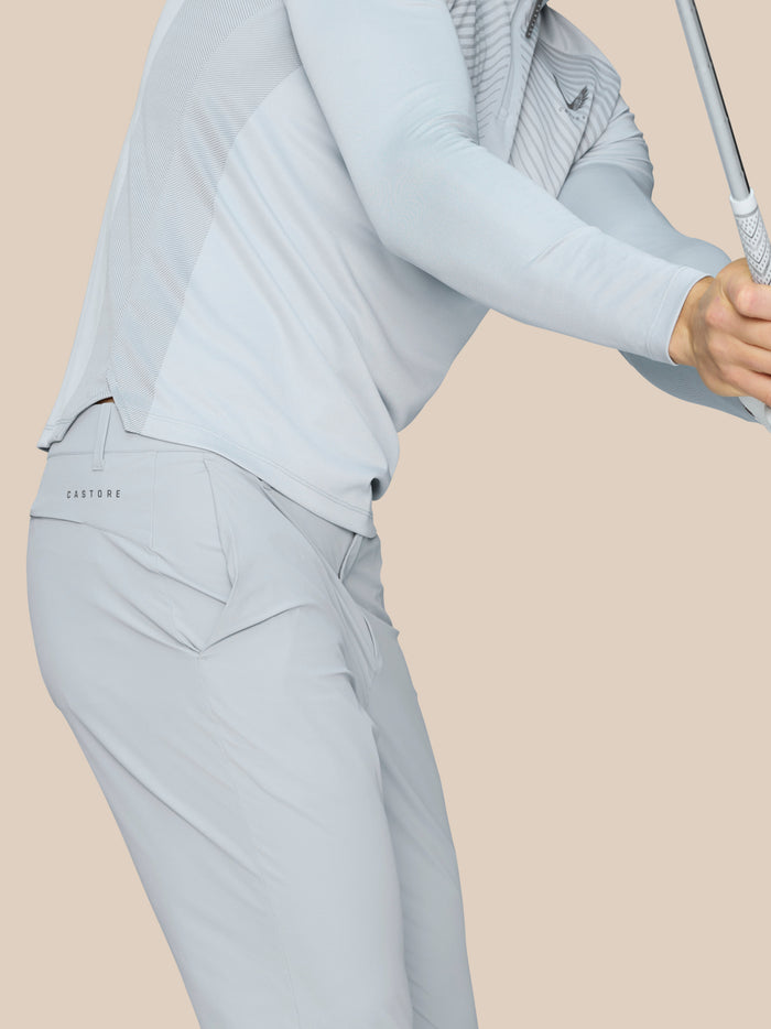 Back hip area view of light grey golf pants with Castore branding.