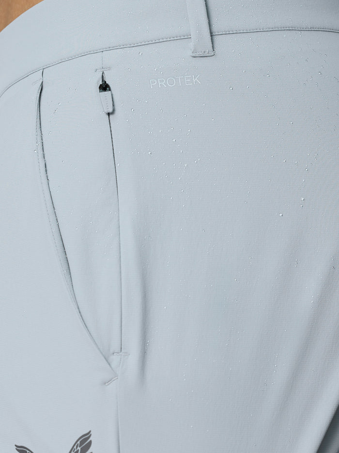 Back pocket area of light grey golf trousers featuring ProTek fabric and zipper
