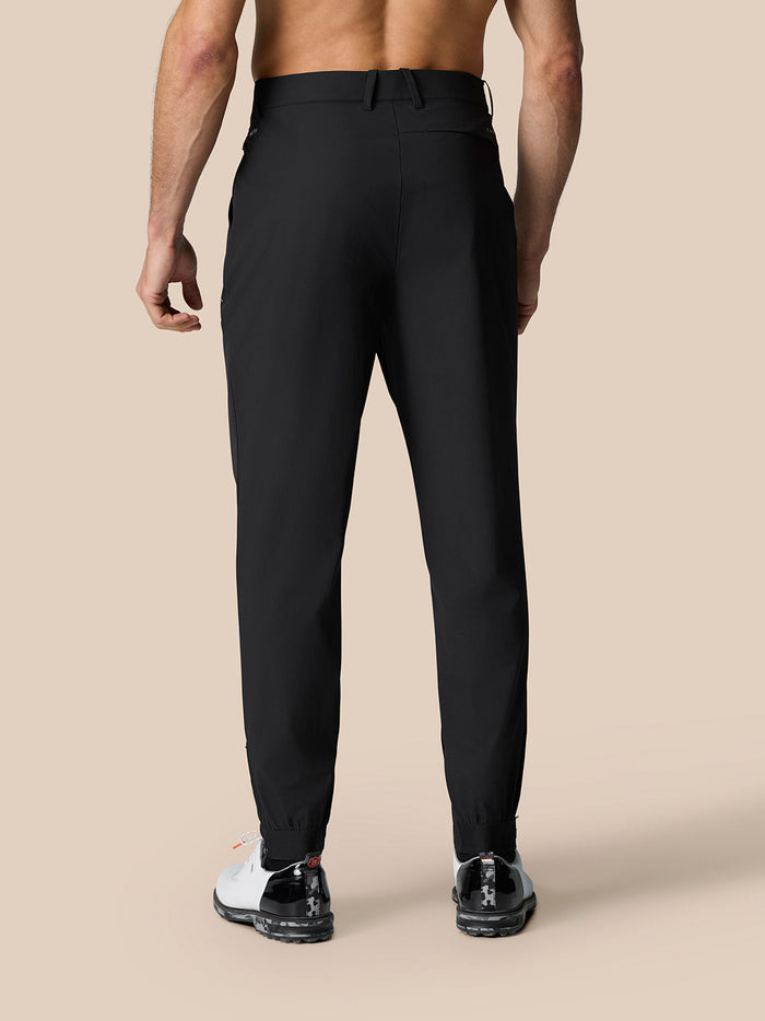 Back view of black golf trousers with elastic cuffs and belt loops