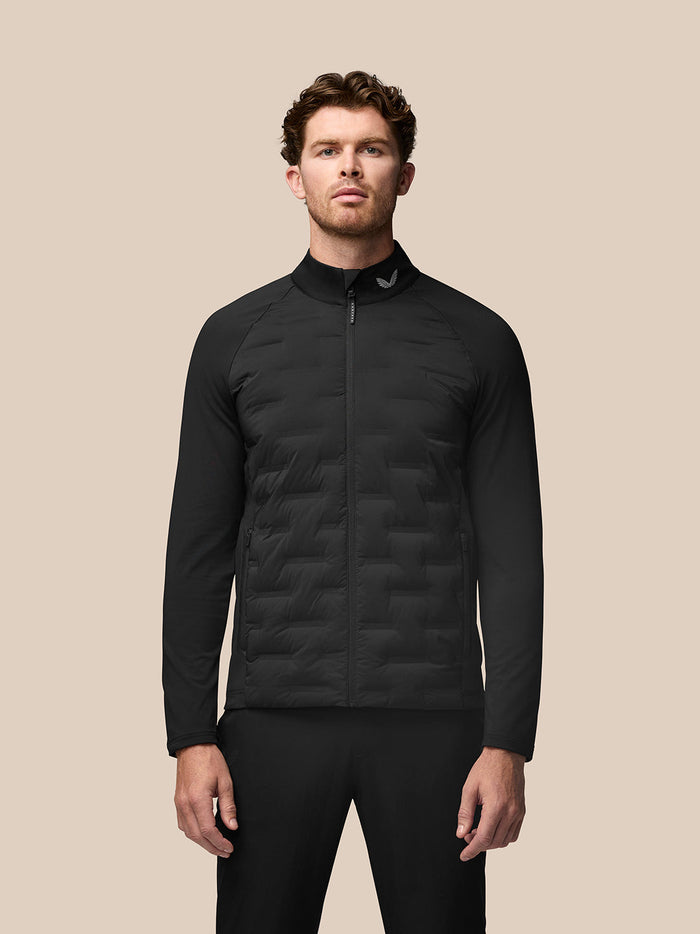 Male model wearing black Golf Pinnacle Jacket with stand collar and quilted front panels.