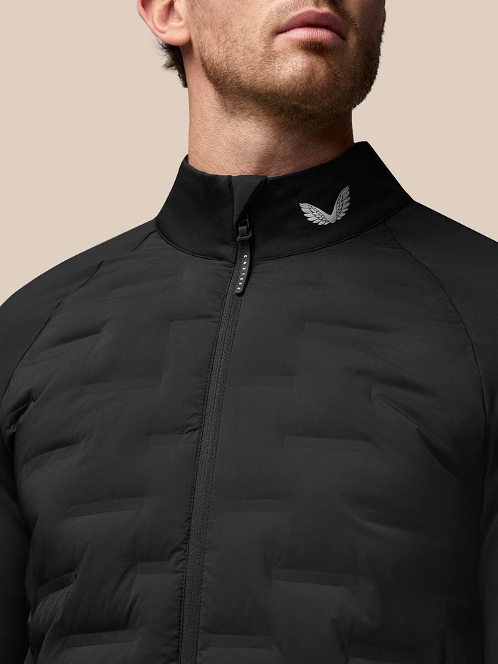 Close-up of the black Pinnacle Golf Jacket collar with front zip and wing emblem